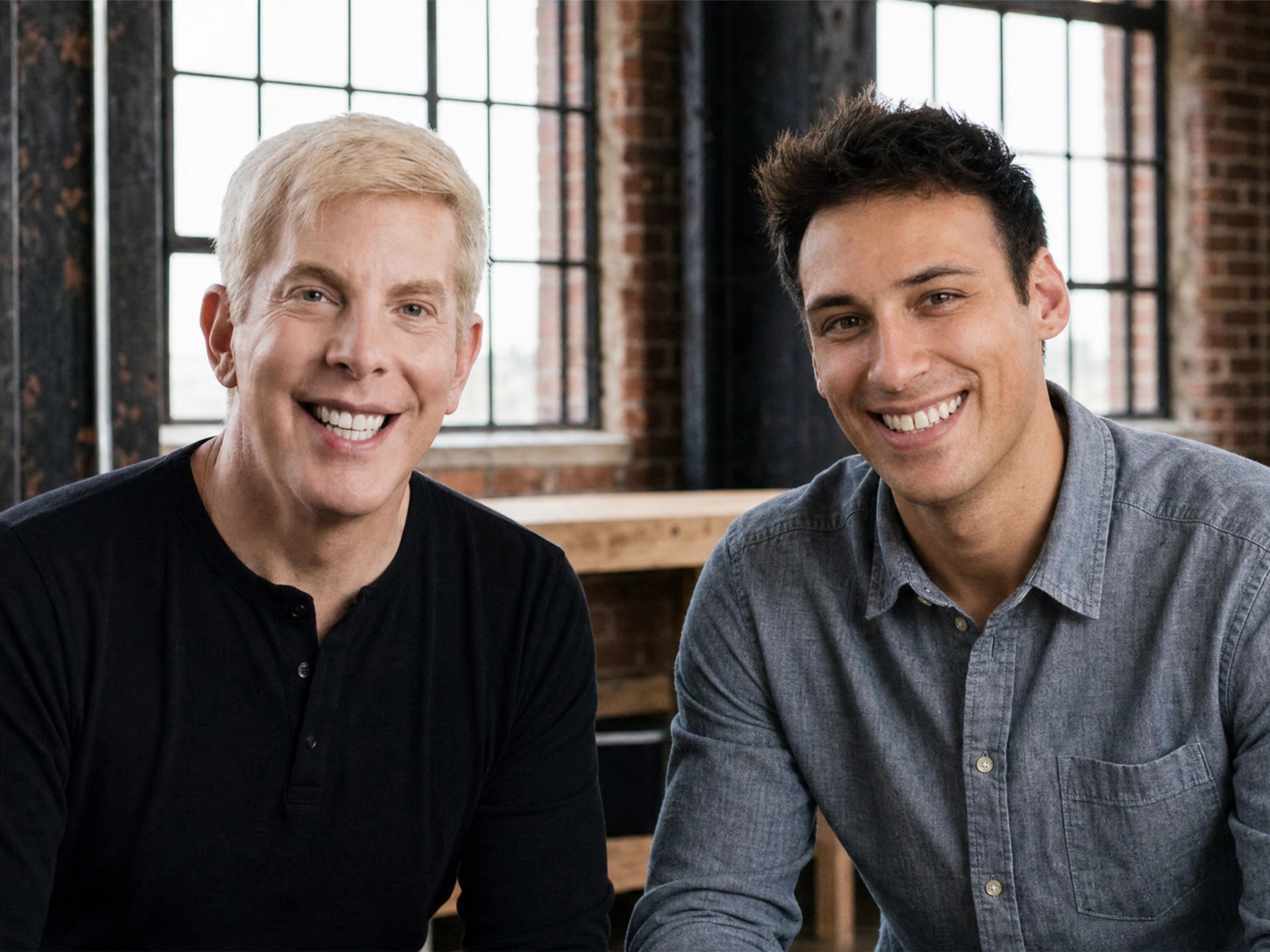 Mike X Franzini and Nick Carter in a brick-walled loft, smiling together.